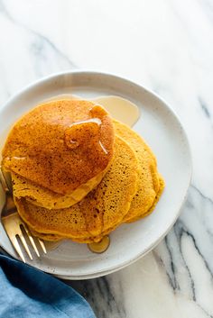 a stack of pancakes on a white plate