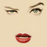 an image of a woman's face with blue eyes and red lipstick on it