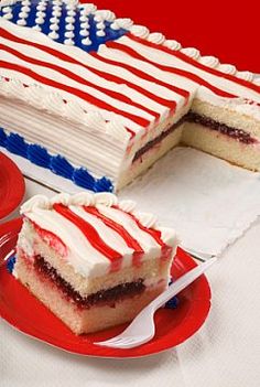 a red, white and blue cake sitting on top of a table next to a plate