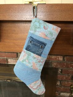 an old pair of jeans hanging from a fireplace mantel with a pocket on it