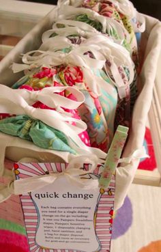 a basket filled with lots of cloths sitting on top of a table