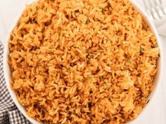 a white bowl filled with rice on top of a table