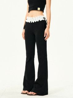 Discover the elegance of effortless style with our Ruffle Trim Flared Elastic Waist Pants, perfect for any wardrobe. These trousers boast a unique blend of comfort and chic with an elasticated waist adorned with a delicate ruffle trim, offering both a secure fit and a touch of femininity. Crafted from soft, breathable fabric, these flared pants are not only stylish but also comfortable for all-day wear. Their sophisticated silhouette and versatile black color make them an ideal choice for both c Trendy Wide Leg Ruffled Pants, Chic Flare Pants With Ruffles, Stretch Ruffled Trousers, Ruffled Stretch Trousers, Trendy High Waist Ruffled Pants, Chic Ruffled Trousers, Trendy Ruffled Pants, Elegant Flared Ruffle Bottoms, Wide Leg Ruffled Pants For Loungewear