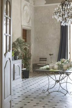 a dining room with a table and chandelier