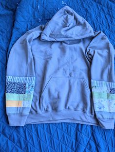 Handmade upcycle hoodie with two quilted sleeves.  Hoodie comes in beige, gray or dark gray.  You select primary sleeve color.  Check the examples.  Your hoodie will not be an exact match. Hoodie Patchwork, Patchwork Hoodie, Quilted Sleeves, Patchwork Clothes, Sewing Projects Clothes, Work Diy, Sarasota Fl, Patch Work, Dark Gray