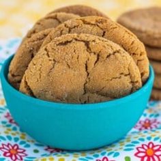 two cookies in a blue bowl next to each other