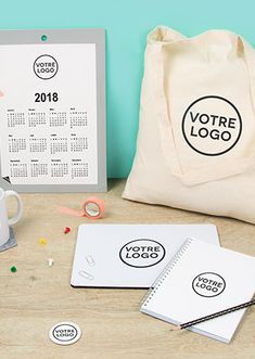 a table with various items on it including a bag, calendars and other office supplies