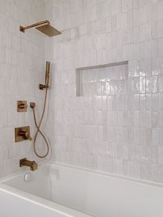 a bathroom with a tub and shower head