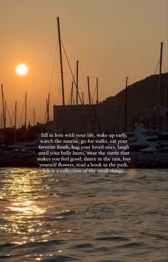 the sun is setting over some boats in the water with a quote written on it