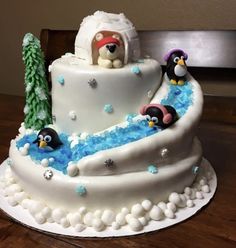 there is a cake with penguins on it