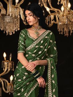 Add a touch of elegance and charm to your wardrobe with our alluring green embroidered tissue silk saree with blouse. Perfect for festive occasions, weddings, and special events, this stunning saree is designed to make you stand out and feel confident.
The green color of the saree exudes a sense of freshness and vibrancy, while the sequin work, embroidery work, and tassels on the pallu add a touch of glamour and sophistication. The similar color silk material blouse with thread embroidery work c Green Dola Silk Pre-draped Saree With Dupatta, Festive Green Pre-draped Saree With Zari Weaving, Embroidered Green Pre-draped Saree In Dola Silk, Green Embroidered Pre-draped Saree, Green Dola Silk Pre-draped Saree For Diwali, Green Tissue Silk Choli For Festive Occasions, Elegant Green Dola Silk Choli, Festive Green Tissue Silk Choli, Green Pre-draped Saree With Resham Embroidery For Diwali