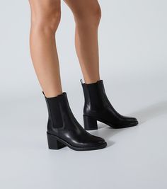 Elevate your style with Albany. Crafted from premium leather, this ankle boot features elastic side panels, a round toe, and a block heel for all-day comfort. Finished in a classic black, these boots are the perfect blend of fashion and function. -Material: Leather -Sole: Rubber -Fit: True To Size -Toe-shape: Round -Features: Block Heel -Heel: 6.5cm