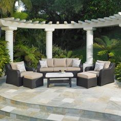 an outdoor living area with couches and tables