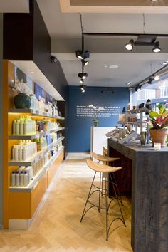 the interior of a store with shelves and stools