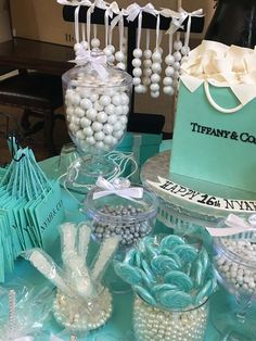 a table topped with lots of candy and candies on top of blue cloth covered tables