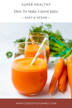 carrots and juice are sitting next to each other on a table with green stems