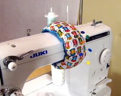 a white sewing machine sitting on top of a table