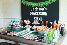 a table filled with lots of desserts and drinks on it's sides, including cupcakes