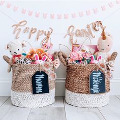 two baskets filled with stuffed animals sitting on top of a wooden floor next to a happy new year sign