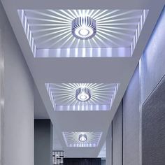 an empty hallway with three lights on the ceiling