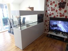 a tv sitting on top of a white counter in a living room