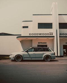 a grey car parked in front of a building