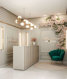 a white reception area with a green chair and flowers on the front desk, along with lights hanging from the ceiling