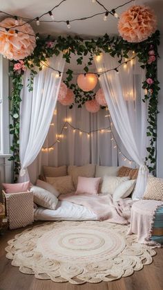 a living room filled with lots of furniture and flowers hanging from the ceiling above it