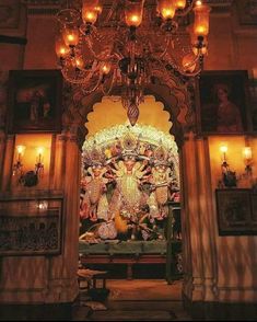 an ornate shrine with chandeliers and paintings on the walls