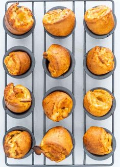 twelve muffins with cheese in the middle on a baking tray, ready to be baked