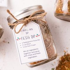 a jar filled with different types of spices next to a tag that says festa dip