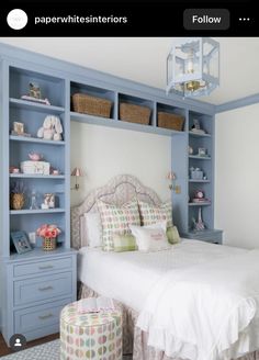 a bedroom with blue bookcases and a white bed in it's center