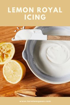 lemon royal icing in a bowl next to sliced lemons