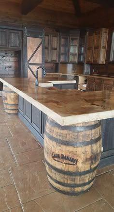 a kitchen with an island made out of wine barrels