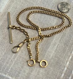 14k curved link antique watch chain with all the spring rings "T" bar, watch hook.  Condition is very good for it's age, pictures show the details.  Length approx. 15", links 5mm in width, wt. hefty 21.6 grams, one spring rings and it's chain could be moved to main chain for a bit extra length(1 1/4").  Late 1800s to early 1900s, vest chain for a watch, timeless intriguing design with many clasps for hanging charms, watch, fobs, etc.  Could be worn as a bracelet or necklace with added chain, or Vintage 14k Gold Necklaces With Curb Chain, Antique Jewelry With Oval Link Curb Chain, Classic Antique Gold Chain Jewelry, Antique Oval Link Gold Chain Jewelry, Antique Gold Jewelry With Curb Chain, Victorian Link Jewelry With Curb Chain, Antique 14k Gold Oval Link Jewelry, Victorian Gold Curb Chain Jewelry, Victorian Gold Jewelry With Curb Chain