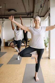 a group of people doing yoga in a room