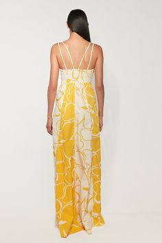 DESCRIPTION This statement maxi dress is made from the softest cotton in our Whirlwind print that feels like a burst of morning sun. It's detailed with wide vertical panels that drop from the bust and pool at the feet for an elongating effect. The low V neck is strung by twin straps that continue down the back for added drama as you work the room. * Prints and colours may vary slightly due to the handmade nature of each piece. Color: Whirlwind DETAILS & CARE INSTRUCTIONS 100% Sustainable Cotton Cotton Beachwear Maxi Dress For Daywear, Cotton Maxi Dress For Beach Daywear, Cotton Maxi Dress For Daywear And Beachwear, White Printed Poolside Dress, White Printed Dress For Poolside, Printed Cotton Maxi Dress For Day Out, Summer Yellow Cotton Maxi Dress, Floral Print Maxi Dress For Resort Season, Cotton Maxi Dress For Spring Beachwear