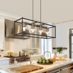 a kitchen island with lights hanging over it