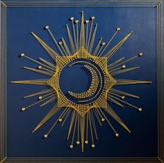 an intricately designed sun and moon on a blue background with gold trimmings