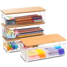 three clear acrylic boxes with different types of markers and pencils in them