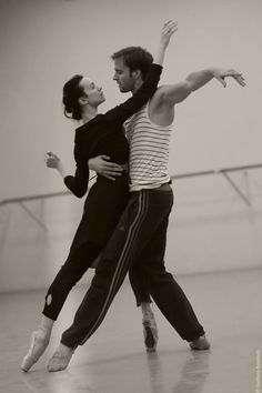 two people are dancing together in an empty dance studio with their arms around each other