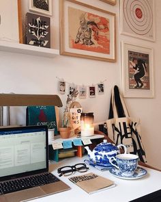 a laptop computer sitting on top of a white desk