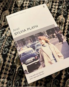 a book with an image of a woman walking down the street in front of cars