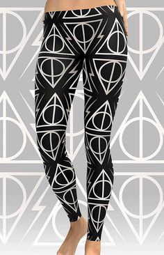 a woman wearing black and white leggings with harry potter symbols on it, in front of a gray background