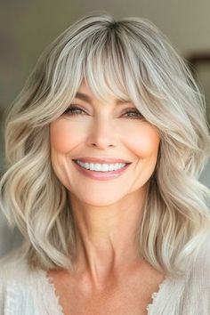 Save this pin for the best hairstyles for women over 60 with bangs. Soft, wavy layers that fall to the shoulders create a flattering look for women in their 60s. The gentle waves add body, while the layered cut removes weight and allows hair to flow naturally. Bang Haircuts, Lady Hairstyles, Bangs Cut, Bride Hairstyles Updo, Hairstyle Hacks, 60 Hair, Best Hairstyles For Women, Wavy Layers, 60 Hairstyles