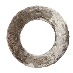 a white and brown wreath with silver foil on it's edges, in the shape of a circle