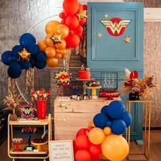 an assortment of balloons and decorations in a room