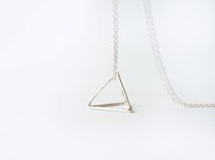 This edgy minimalist necklace has a hand forged sterling silver pyramid pendant, made of joined triangles, hanging from a sterling silver chain. This Silver Triangle Jewelry For Everyday, Minimalist Geometric Sterling Silver Necklace, Minimalist Silver Pyramid Jewelry, Minimalist Silver Triangle Necklace, Minimalist Sterling Silver Triangle Necklace, Edgy Minimalist, Pyramid Necklace, Pendant Necklace Long, Necklace Minimalist Jewelry