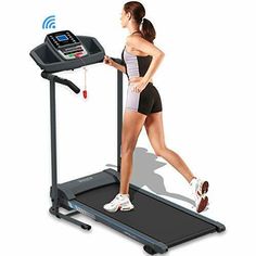 a woman is running on a treadmill