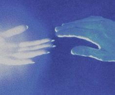 two hands reaching towards each other in front of a blue background with light coming from behind them